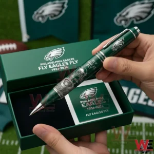 Hands presenting a Philadelphia Eagles Fly Eagles Fly 1933 2026 commemorative pen in a green gift box with a matching card and Eagles branding in a football themed scene!