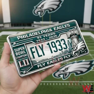 Hand holding a Philadelphia Eagles license plate featuring fly one nine three three text super bowl champions details and eagle graphics.
