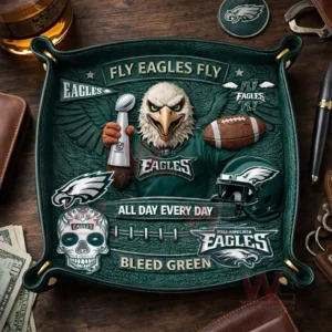 Green leather valet tray with Philadelphia Eagles mascot holding a trophy fly eagles fly text football helmet logos and bleed green slogan shown on a wooden desk with keys watch pen and drink!