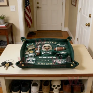 Green Philadelphia Eagles leather valet tray on an entryway table holding keys coins watch and small items with fly eagles fly and bleed green text shown in a home hallway setting!