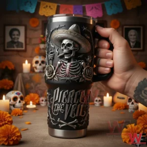Hand holding a Pierce the Veil themed insulated tumbler with skeleton artwork in a Day of the Dead style setting!