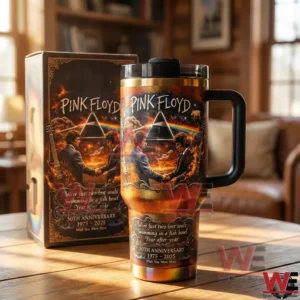 Handled insulated tumbler with Pink Floyd prism and handshake artwork displayed beside a matching gift box on a wooden table in a warm indoor setting!