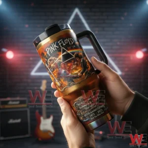 Pink Floyd Wish You Were Here 50th Anniversary Stanley Tumbler 4 Hands holding a Pink Floyd prism themed handled tumbler in front of a music studio background with guitars and stage lights!
