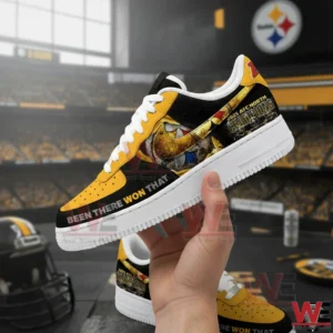 Hand holding a black and yellow Steelers themed low top sneaker with white laces and Been There Won That text in a football stadium setting.