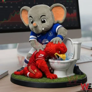A green crocodile mascot figurine holding a blue bird character over a toilet on a grass base!
