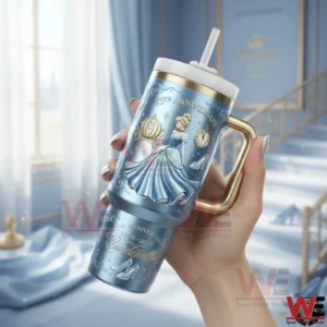 Hand holding a blue Cinderella anniversary insulated tumbler with handle and straw featuring a princess illustration and elegant decorative details!