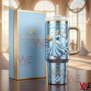 Cinderella anniversary insulated tumbler with gold handle and straw displayed next to a matching blue gift box in a bright palace hall!