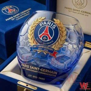 A close up view of a Paris Saint Germain commemorative glass presented in a blue display case with a detailed anniversary logo and refined decorative elements!