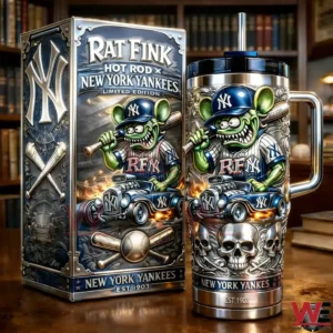 Stainless travel tumbler with metal handle and black lid beside a matching collector box featuring Rat Fink Hot Rod New York Yankees Limited Edition artwork with a green cartoon character hot rod flames and New York Yankees Est Nineteen Zero Three text in a library setting.