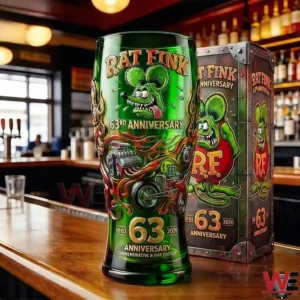 Rat Fink anniversary beer glass on a bar counter with bold green artwork and a collectible box in a bar setting!