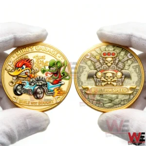White gloved hands holding two gold edged garage challenge coins one with a hot rod cartoon design and one with a skull engine and Built For Speed text!