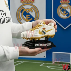 A close side view of a Real Madrid building block soccer boot displayed on a black stand with iconic club colors!