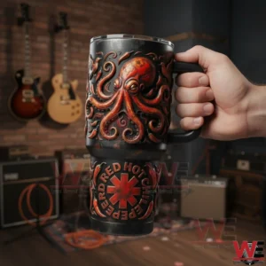 Hand holding a black handled tumbler with embossed red octopus and Red Hot Chili Peppers logo in a music studio with guitars and amplifiers!