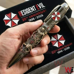 Hand holding a Resident Evil anniversary collector pen with engraved creature design umbrella emblem and premium display box!