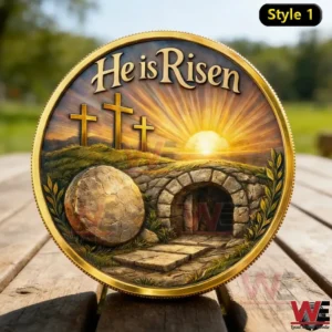 He is Risen Easter coin with an empty tomb sunrise scene and three crosses displayed on a wooden surface outdoors!