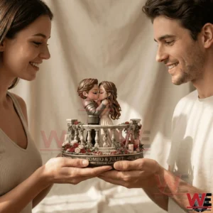Couple holding a romantic couple figurine together while smiling in a soft indoor setting!