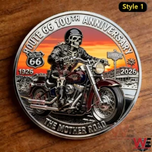 A Route 66 one hundredth anniversary commemorative coin featuring a skeleton biker on a classic motorcycle with desert scenery and sunset colors!