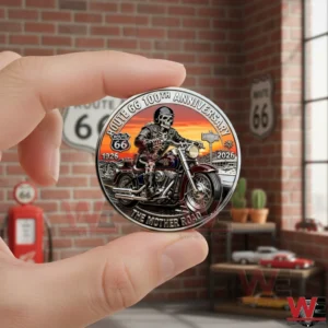 ROUTE 66 100TH ANNIVERSARY COMMEMORATIVE COIN 5 A hand holding a Route 66 one hundredth anniversary commemorative coin with skeleton biker artwork and retro background!