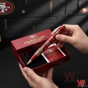 Hands holding an open red gift box with a San Francisco 49ers commemorative pen featuring red body gold accents 49ers logo and 80th Anniversary 1946 2026 text with a matching card inside!