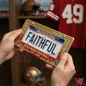 A San Francisco 49ers license plate frame held by hands featuring Gold Rush football design and Faithful text with team memorabilia in the background!