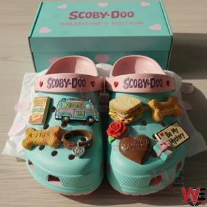 Scooby Doo Be My Mystery Clogs Crocs with Charms 5 Two teal Scooby Doo clogs with pink straps and themed charms arranged side by side in front of a Scooby Doo Valentines Edition box!