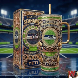 Front view of a green blue and gold insulated tumbler with an ornate Seattle Seahawks Emerald City design displayed next to a matching decorative box!