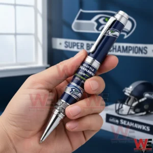 Hand holding a Seattle Seahawks commemorative pen with team colors and a professional sports setting!