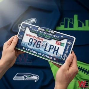 Hands holding a sports license plate frame with bold football styling inside a fan decorated space!