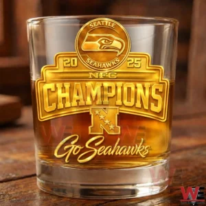 A detailed front view of a Seattle Seahawks champions whiskey glass resting on a wooden table with rich reflections and sharp focus!