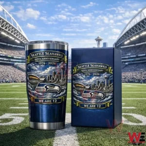 Navy blue Seattle Seahawks 50th anniversary tumbler with matching gift box on a football field inside a stadium with fans in the background!