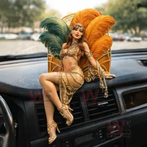 Showgirl figurine in a gold jeweled outfit sitting on a car dashboard with large green and orange feather wings and a blurred street background!