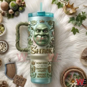 Shrek themed tumbler with ogre face crown symbols vine style handle clear lid and straw displayed on a white fur background!