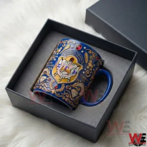 Blue ceramic mug with intricate gold embellishments and a Sigma Gamma Rho crest resting inside a fitted gift box on a soft white surface!