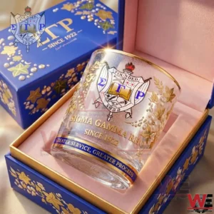 Commemorative Sigma Gamma Rho whiskey glass with gold detailing placed in a blue gift box designed to honor the sorority history and values since 1922!