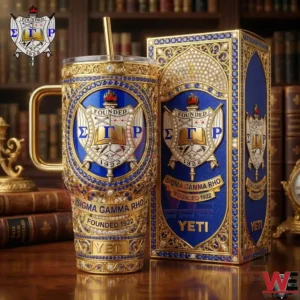 A YETI tumbler and box with Sigma Gamma Rho crest placed on a polished wooden surface surrounded by classic books and refined decor! v