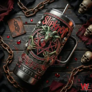 A top angled view of a Slipknot YETI tumbler placed among chains skull props and red stones creating a heavy metal mood!