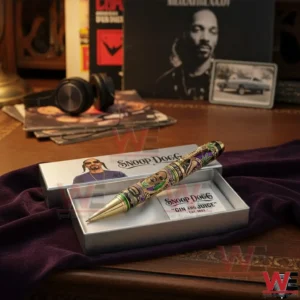Snoop Dogg collector pen in an open presentation box on velvet fabric with music memorabilia and album art in the background!