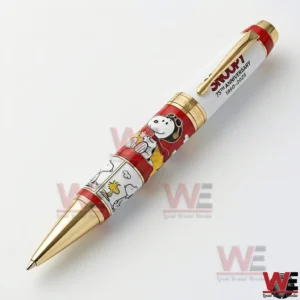 Close up of a Snoopy 75th anniversary pen with red and white character illustrations and gold trim on a white background!