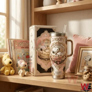 A Snoopy insulated tumbler and collector box placed on a wooden shelf surrounded by books soft decor and classic Snoopy items!