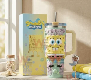 SpongeBob SquarePants themed tumbler with handle and straw displayed beside its box in a sunlit indoor setting!