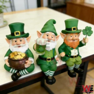 Three leprechaun figurines in green clothing seated on a table edge with a pot of gold a beer mug and a shamrock!