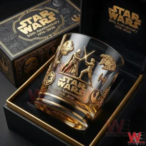A Star Wars fiftieth anniversary whiskey glass placed inside a presentation box featuring detailed character scenes and polished gold accents!