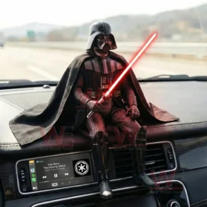 Darth Vader figure on a car dashboard holding a red lightsaber with a highway view outside the windshield!