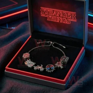 Silver adjustable charm bracelet in a black and red gift box with Stranger Things neon logo featuring dice friends dont lie bicycle demogorgon flower and cassette charms.