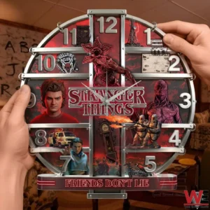 Hands holding a round themed wall clock with red and black artwork large metallic numbers and dramatic character scenes around a central title!