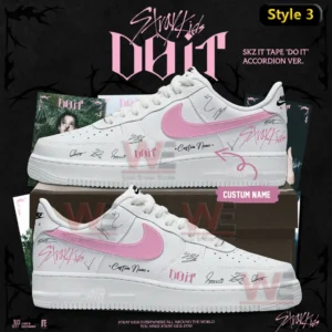White high top Air Jordan one sneaker with pink swoosh do it themed signature markings and custom name displayed on a shoebox with Stray Kids album background