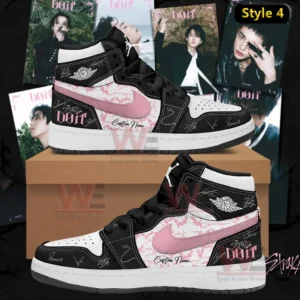 Black and white high top Air Jordan one sneaker with pink swoosh pink patterned panels do it themed accents signature style markings and custom name displayed on a shoebox with album themed background