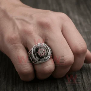 Hand wearing a silver ring with a black gemstone face showing the Supernatural anti possession emblem and engraved text around the bezel!