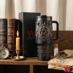 Black insulated tumbler with handle and straw next to a matching box on a wooden shelf with books and candles!