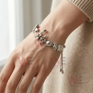 Taylor Swift Long Live All the Magic We Made Adjustable Charm Bracelet 4 Adjustable charm bracelet on a wrist with charms including microphone star guitar thirteen snake disco ball TS letters and outfit charm!